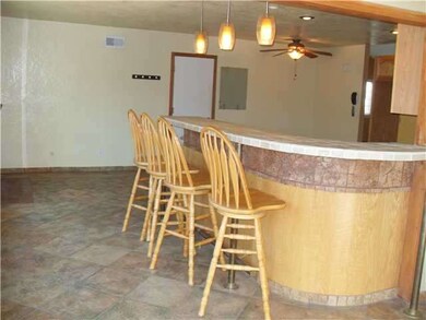 Tile floors and large eating counter top by the ki