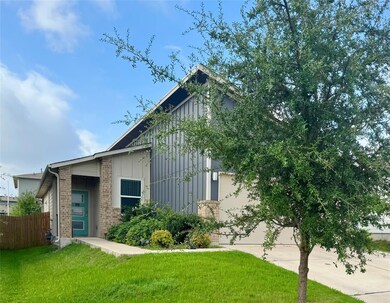 View of front of house featuring a garage, drivew