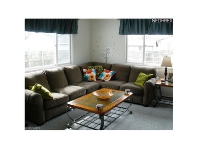 The living room is filled with sunlight and has plenty of room to enjoy friends and family.