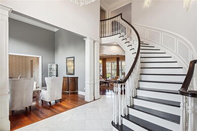 Curving Staircase Greets You in Foyer