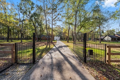 A welcoming gated entrance leads to this secluded 2.62-acre country home