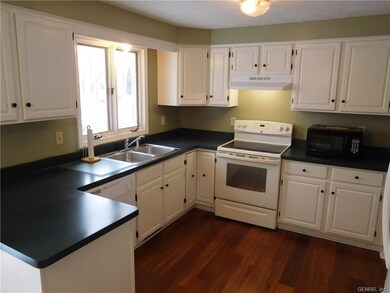 White kitchen cupboards have been painted inside a