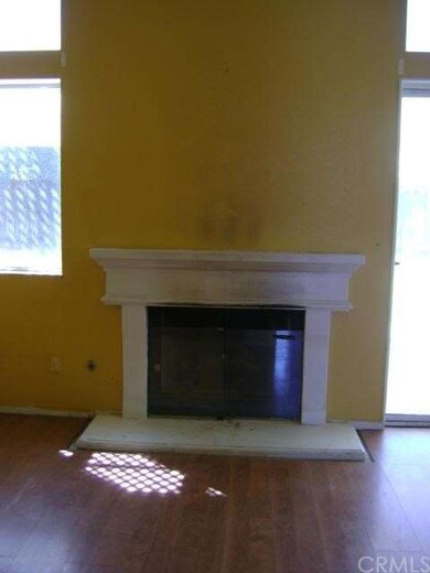 Fireplace in family room - wood flooring. 