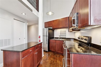 The kitchen has stainless appliances, ample cabine