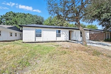 Ranch-style home with a front lawn and brick siding