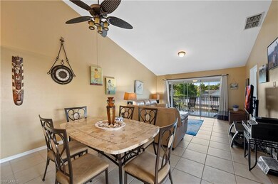 Dining area featuring light tile patterned flooring, a ceiling fan, baseboards, and high vaulted ceiling