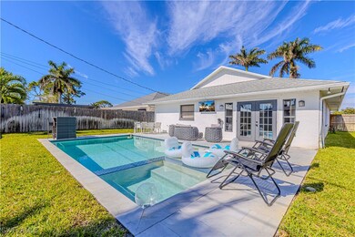 View of pool with french doors, a patio, and a law