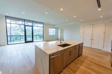 Kitchen featuring a sink, open floor plan, visibl