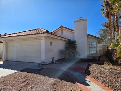 View of front of house with a chimney, stucco sidi