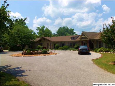 Circle driveway encompassing a pleaseant, stone fo