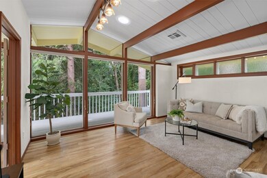 The vaulted ceilings with exposed beams not only enhance the natural light but also creates a feeling of openness, perfect for both relaxing and entertaining.