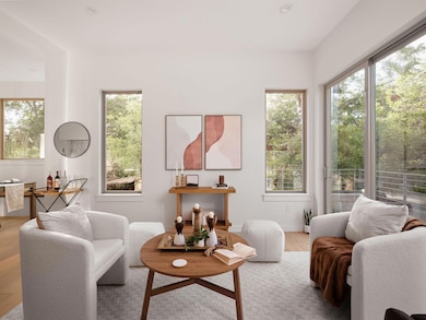 Living area featuring wood finished floors, plenty of natural light, and recessed lighting