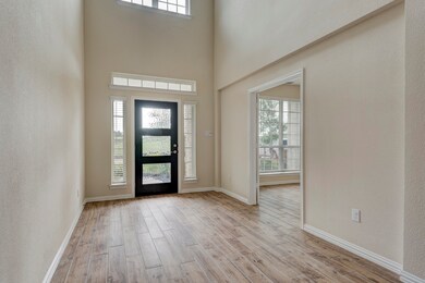 You're greeted by a grand foyer with soaring ceilings.