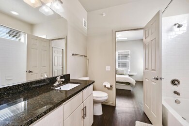 Bathroom with wood finished floors, vanity, showe