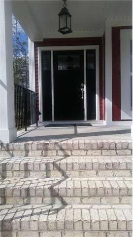 Masonry porch and brick steps entry into home.
