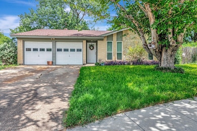 Ranch-style house with a garage, driveway, a front lawn, brick siding, and a shingled roof