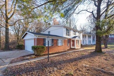 Another view of the Front and Side of this Lovely Home with a Beautiful Setting of Privacy and Trees. Oversize 2 Car Side Garage. Classic Style!