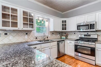gourmet kitchen with gas range and stainless steel