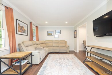 Living area with dark wood finished floors, recess