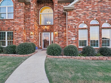 Stunning front door with large windows along front of home