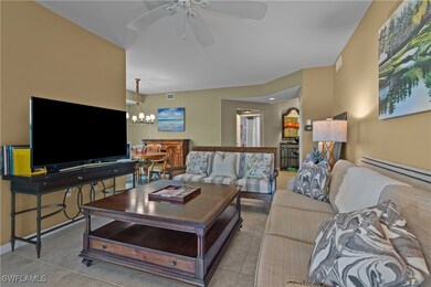 Tiled living room with ceiling fan with notable ch