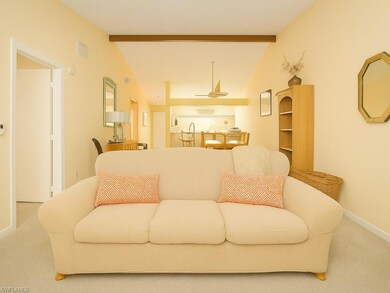 Carpeted living room featuring baseboards