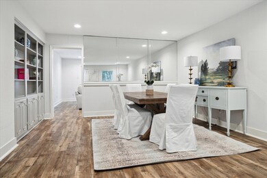 A mirrored wall and built in book shelves bring elegance and functionality to this space.