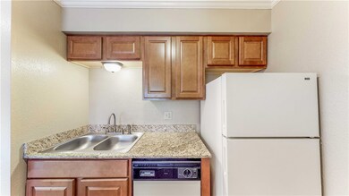 Kitchen with light countertops, a sink, freestandi
