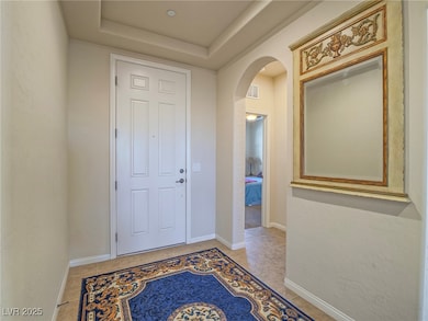 Foyer with baseboards, light tile patterned floori