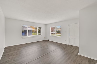 Unfurnished room featuring wood finished floors and a textured ceiling