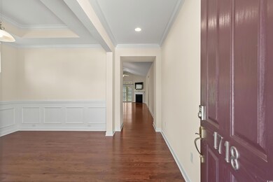Corridor with dark wood-type flooring and ornament