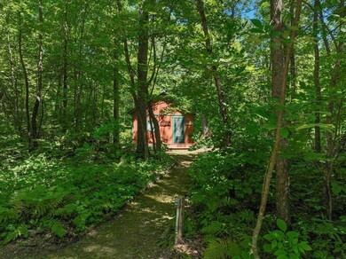 A landscaped path leads to the cabin