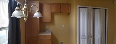 Kitchen featuring light countertops and brown cabinets