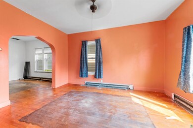 Spare room featuring a baseboard heating unit and 