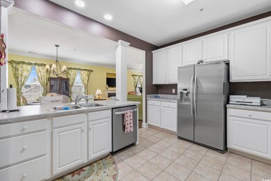 Kitchen with light countertops, appliances with st