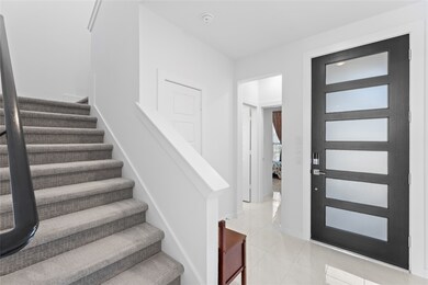 Bright entryway with soaring ceilings.