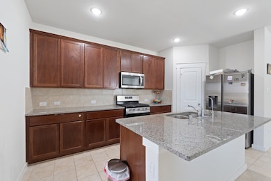 The gourmet kitchen features a spacious island wit