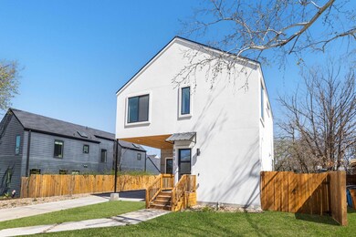 Rear view of property with stucco siding