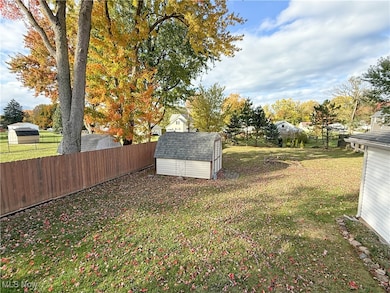 Fenced backyard with a storage unit