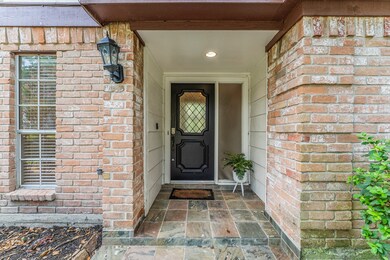 Tiled entry with fogged-glass window adding to thi