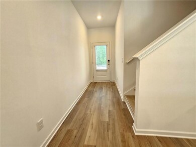 Doorway to outside featuring wood finished floors, stairway, and recessed lighting