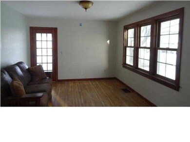 The living room has a door that leads to the cover