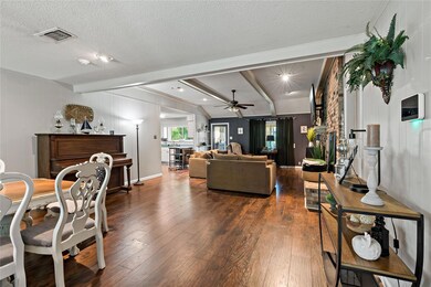 Living room with a textured ceiling, lofted ceilin