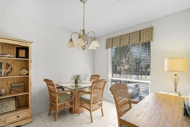 Dining space with light tile patterned floors, a c