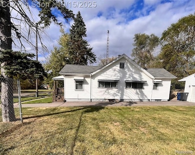 Rear view of house with a shingled roof