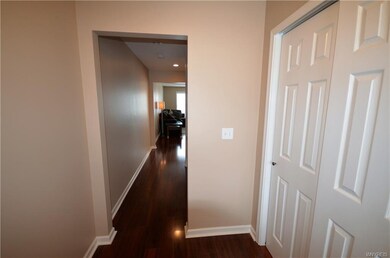 Foyer with a double closet and hardwood floors.