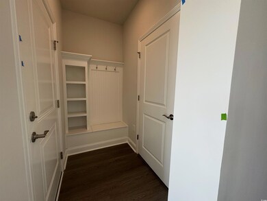 Mudroom featuring dark wood finished floors and ba