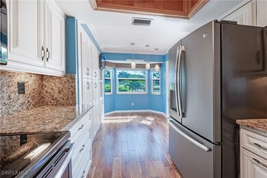 Kitchen with wood-type flooring, stainless steel a