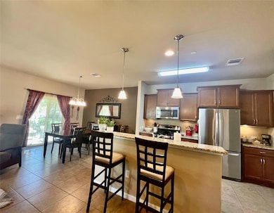Kitchen with visible vents, decorative backsplash