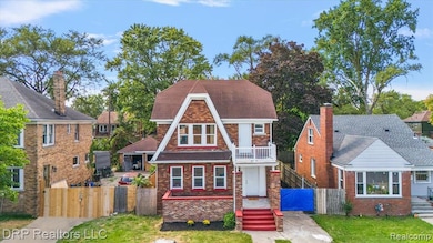 View of front of house featuring a gate and brick siding